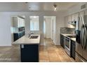 Charming kitchen with granite island, stainless steel appliances, and decorative tile backsplash at 2838 E Contessa St, Mesa, AZ 85213