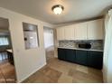 Cozy kitchen features updated cabinets and countertops, stainless microwave, and mosaic backsplash at 2838 E Contessa St, Mesa, AZ 85213