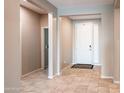 Inviting foyer with neutral color scheme and tile flooring, offering a seamless transition into the home at 37252 N Big Bend Rd, San Tan Valley, AZ 85140