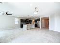 Spacious open-concept kitchen featuring a large island, sleek dark cabinetry, and stainless steel appliances at 37252 N Big Bend Rd, San Tan Valley, AZ 85140