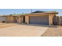 Photo of the front of a house with desert landscaping, a large driveway, and an attached one car garage at 3825 W Royal Palm Rd, Phoenix, AZ 85051