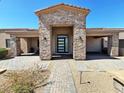 Charming home entrance featuring decorative stone, overhead lighting, and brick paver walkway at 4008 La Ultima Piedra --, Carefree, AZ 85377