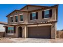 Beautiful two-story home featuring a desert landscape, brick driveway and a two car garage at 40213 W James Ln, Maricopa, AZ 85138