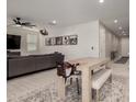 Bright living and dining area with light wood-look floors and an open layout at 40213 W James Ln, Maricopa, AZ 85138