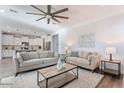 Bright living room with comfortable seating, stylish decor, and an open view to the kitchen at 4360 N 186Th Ln, Goodyear, AZ 85395