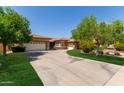 Charming single-story home with a long driveway, three-car garage, and well-maintained landscaping at 4404 W Olney Ave, Laveen, AZ 85339