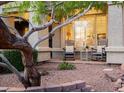 Inviting front porch with two Adirondack chairs, a small table, and desert landscaping around the entryway at 4422 E Spur Dr, Cave Creek, AZ 85331