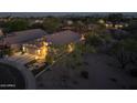 Aerial dusk view of a single-Gathering home and neighborhood, beautifully landscaped with a backyard pool at 4605 E Swilling Rd, Phoenix, AZ 85050
