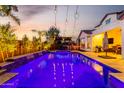 Stunning backyard pool with cascading waterfalls and lush landscaping, great for relaxation and entertainment at 5212 S Seton Ct, Gilbert, AZ 85298