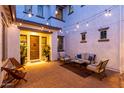 Charming outdoor seating area with ambient cafe lighting, stone pillars and comfortable seating at 5212 S Seton Ct, Gilbert, AZ 85298