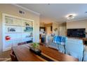 Inviting dining area with a wooden table and a view of the adjacent living room and kitchen at 5345 E Van Buren St # 307, Phoenix, AZ 85008