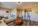 Open-concept living space featuring sleek flooring, a cozy seating area, and modern lighting at 5345 E Van Buren St # 307, Phoenix, AZ 85008
