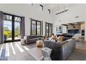 Bright living room with high ceilings, large windows, comfortable seating, and seamless indoor/outdoor flow at 5929 E Indian School Rd, Phoenix, AZ 85018