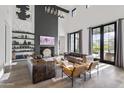 Spacious living room boasts a high ceiling, fireplace, modern decor, and access to the outdoors at 5929 E Indian School Rd, Phoenix, AZ 85018