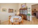 Cozy dining room featuring a wooden table with seating for four and decorative china cabinet at 6102 E Inglewood St, Mesa, AZ 85205