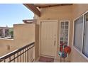 Cozy condo entrance featuring a stylish door with a welcome mat and glass block window at 7021 E Earll Dr # 204, Scottsdale, AZ 85251