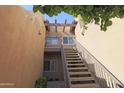 Exterior stairway leading to a second-level condo, showcasing modern design and accessibility at 7021 E Earll Dr # 204, Scottsdale, AZ 85251