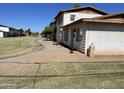 Exterior view of a multi-Gathering home with a well-maintained lawn and a concrete walkway at 7109 W Wolf St, Phoenix, AZ 85033