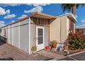 View of the property with a covered porch, desert landscaping, and updated siding at 730 S Country Club Dr # Ofc, Mesa, AZ 85210
