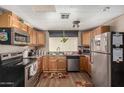 Well-equipped kitchen featuring modern appliances, wood cabinets, and updated countertops at 730 S Country Club Dr # Ofc, Mesa, AZ 85210