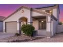Daylight view of home highlighting the covered porch, two-car garage, and neutral facade at 7319 S 56Th Dr, Laveen, AZ 85339