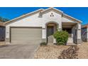 Welcoming home exterior with two-car garage, neutral color scheme, and easy-care landscaping at 7319 S 56Th Dr, Laveen, AZ 85339
