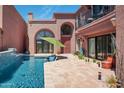 Private pool with tiled patio, cacti, and archways leading to the house at 7530 N Via De La Siesta --, Scottsdale, AZ 85258