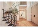 Elegant staircase with black iron railing and natural light at 7530 N Via De La Siesta --, Scottsdale, AZ 85258