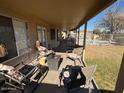 Covered patio with outdoor seating, perfect for entertaining or enjoying a relaxing evening at 7813 E Covina St, Mesa, AZ 85207
