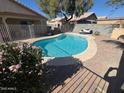 Backyard oasis with refreshing pool, beautiful plants, and comfortable lounge area for relaxation at 7813 E Covina St, Mesa, AZ 85207