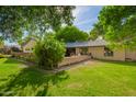 View of back yard showing a well-manicured lawn with a brick patio area at 8302 S Jentilly Ln, Tempe, AZ 85284