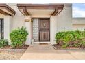 Close up of front entrance with decorative door and well-maintained landscaping at 919 E Villa Maria Dr, Phoenix, AZ 85022