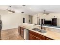 Open-concept layout overlooking the kitchen with tile flooring, granite counters, and stainless-steel appliances at 937 N Marble St, Gilbert, AZ 85234