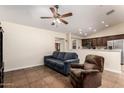Cozy living room featuring a blue sofa, recliner, and tile flooring at 937 N Marble St, Gilbert, AZ 85234