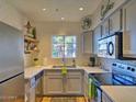 Modern kitchen with stainless steel appliances, white countertops, subway tile backsplash and a garden window at 9450 E Becker Ln # 2099, Scottsdale, AZ 85260