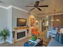 Comfortable living room with a cozy fireplace, modern decor, and an orange accent chair at 9450 E Becker Ln # 2099, Scottsdale, AZ 85260