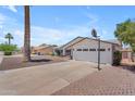 A single-story home features a driveway, garage, basketball hoop and landscaping at 1020 E Concorda Dr, Tempe, AZ 85282