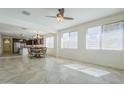 Bright living area with tile floors, multiple windows, and an open layout connecting to the kitchen at 10609 E Durant Dr, Mesa, AZ 85212