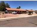 Single story home with an attached garage and low maintenance landscaping at 1156 E Vinedo Ln, Tempe, AZ 85284