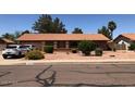 Single story home with a low maintenance desert rock front yard and an attached garage at 1156 E Vinedo Ln, Tempe, AZ 85284