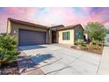 Attractive single-story home with desert landscaping, a tile roof, and a two-car garage at 13448 W Miner Trl, Peoria, AZ 85383