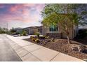 Desirable single-story home with well-maintained desert landscaping and a two-car garage at 13448 W Miner Trl, Peoria, AZ 85383