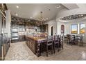 Gourmet kitchen featuring brick backsplash, chandelier, large center island with seating, and adjacent breakfast nook at 13931 E Via Linda --, Scottsdale, AZ 85259