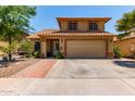 Beautiful two-story home featuring desert landscaping, tile roof, and an attached two car garage at 1723 W Mercury Way, Chandler, AZ 85224