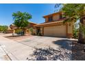 Charming two-story home featuring a tiled roof and a large driveway with ample parking space at 1723 W Mercury Way, Chandler, AZ 85224