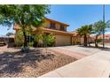 Attractive home with desert landscaping, tile roof, and two car garage at 1723 W Mercury Way, Chandler, AZ 85224