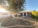 Charming single-story home with manicured landscaping and mature trees in a residential neighborhood at 17371 N 86Th Ave, Peoria, AZ 85382