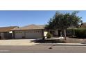 Charming single-story home featuring a three-car garage and mature landscaping at 17371 N 86Th Ave, Peoria, AZ 85382