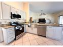 Updated kitchen with stainless steel appliances, stone countertops, and a farmhouse style sink at 17371 N 86Th Ave, Peoria, AZ 85382