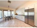 Bright kitchen featuring stainless steel appliances, granite countertops, a table, and tiled floors at 17371 N 86Th Ave, Peoria, AZ 85382